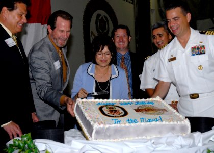 US Navy 091022-N-8283S-062 Capt. Mark Cedrun, commanding officer of the amphibious assault ship USS Boxer (LHD 4) and guests cut a cake in the ship's hangar bay
