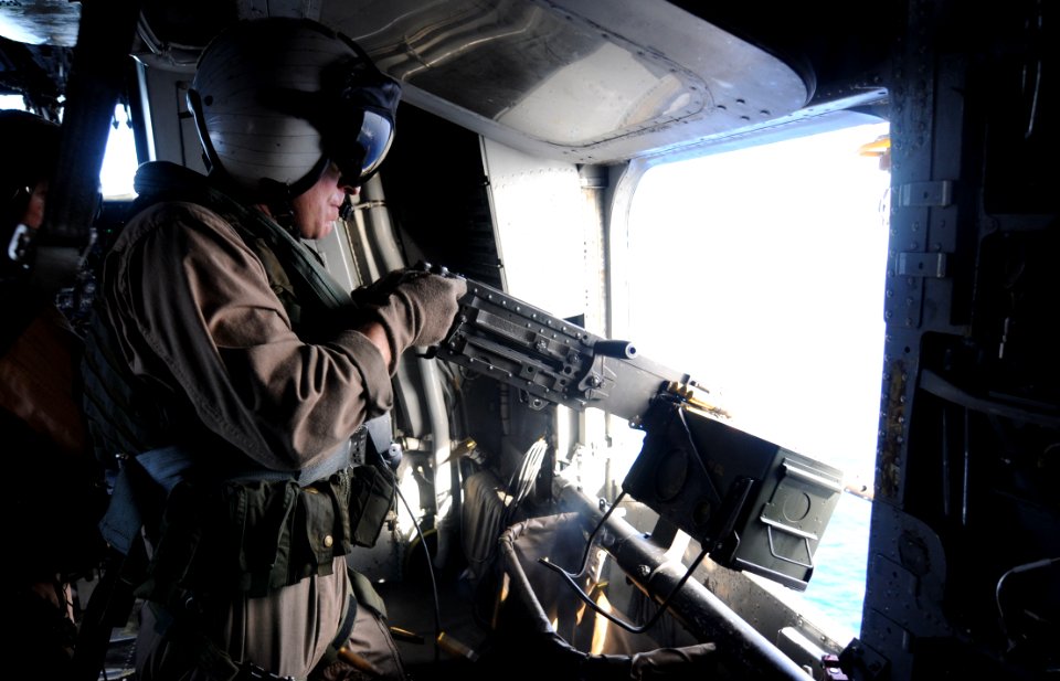 US Navy 091020-N-0890S-060 Cpl. Aaron Ferguson, from Ocala, Fla. assigned to the Iron Horses of Marine Heavy Helicopter Squadron (HMH) 461, fires a .50-caliber machine gun