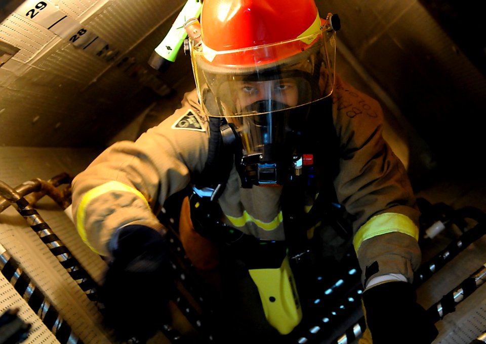 US Navy 091020-N-7280V-247 Damage Controlman 3rd Class Travis Mueller evacuates the fire room during a fuel oil leak drill