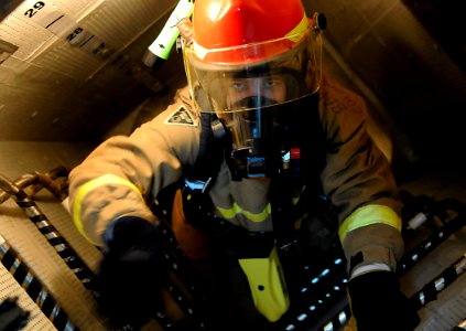 US Navy 091020-N-7280V-247 Damage Controlman 3rd Class Travis Mueller evacuates the fire room during a fuel oil leak drill