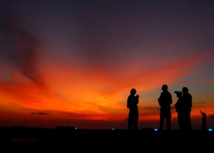 US Navy 091019-N-5538K-115 Flight deck crewmen prepare to conduct night operations aboard the amphibious transport dock ship USS Denver (LPD 9) photo