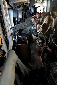 US Navy 091020-N-0890S-171 Sgt. William Krenz, from Woodstock, N.Y. assigned to the Iron Horses of Marine Heavy Helicopter Squadron (HMH) 461, fires a .50-caliber machine gun
