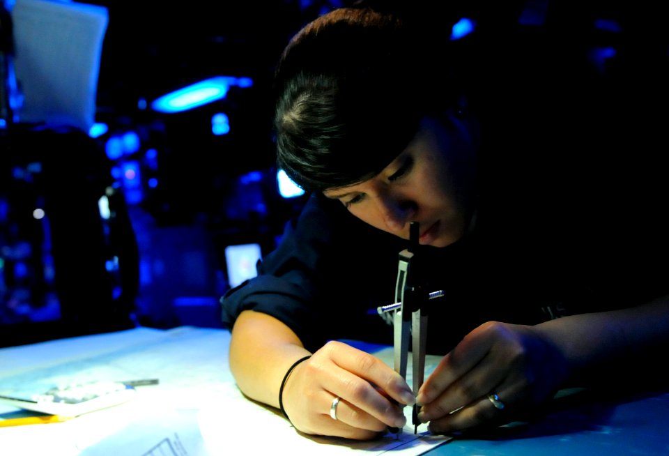 US Navy 091019-N-7478G-091 Operations Specialist Seaman Christina Banegas plots the position of the amphibious command ship USS Blue Ridge (LCC 19) on a chart in the combat information center aboard the ship