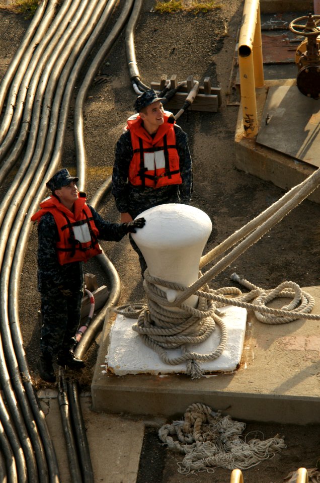 US Navy 091023-N-5319A-004 Sailors prepare to release the lines to the amphibious assault ship USS Nassau (LHA 4) before the ship departs for a three-week Composite Unit Training Exercise (COMPTUEX)