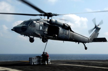 US Navy 091022-N-3038W-939 Aviation Ordnanceman aboard the aircraft carrier USS Nimitz (CVN 68) attach a cargo pendant to a MH-60S Sea Hawk helicopter assigned to the Wildcards of Helicopter Sea Combat Squadron (HSC) 23