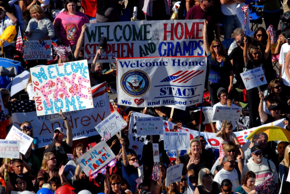 US Navy 091021-N-5586R-152 Friends and family members of Sailors aboard the aircraft carrier USS Ronald Reagan (CVN 76) celebrate as the ship completes her transit into Naval Air Station North Island after a five-month deployme