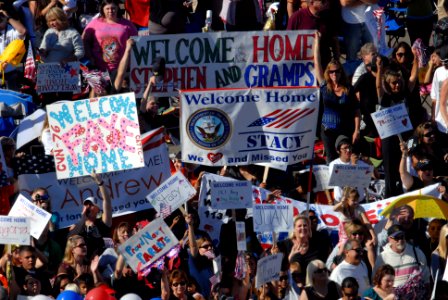 US Navy 091021-N-5586R-152 Friends and family members of Sailors aboard the aircraft carrier USS Ronald Reagan (CVN 76) celebrate as the ship completes her transit into Naval Air Station North Island after a five-month deployme