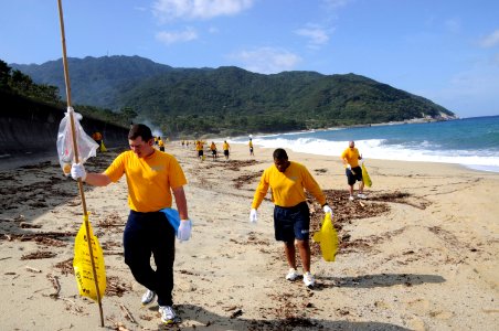 US Navy 091020-N-8335D-101 Sailors assigned to the mine countermeasures ship USS Defender (MCM 2) clean Nagata Maehama beach on the Japanese island of Yakushima