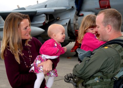 US Navy 091020-N-9860Y-005 t. Cmdr. Chris Bahner from Westminster, Md assigned to the Cougars of Electronic Attack Squadron (VAQ) 139 greets his family during the squadron's homecoming at Naval Air Station Whidbey Island