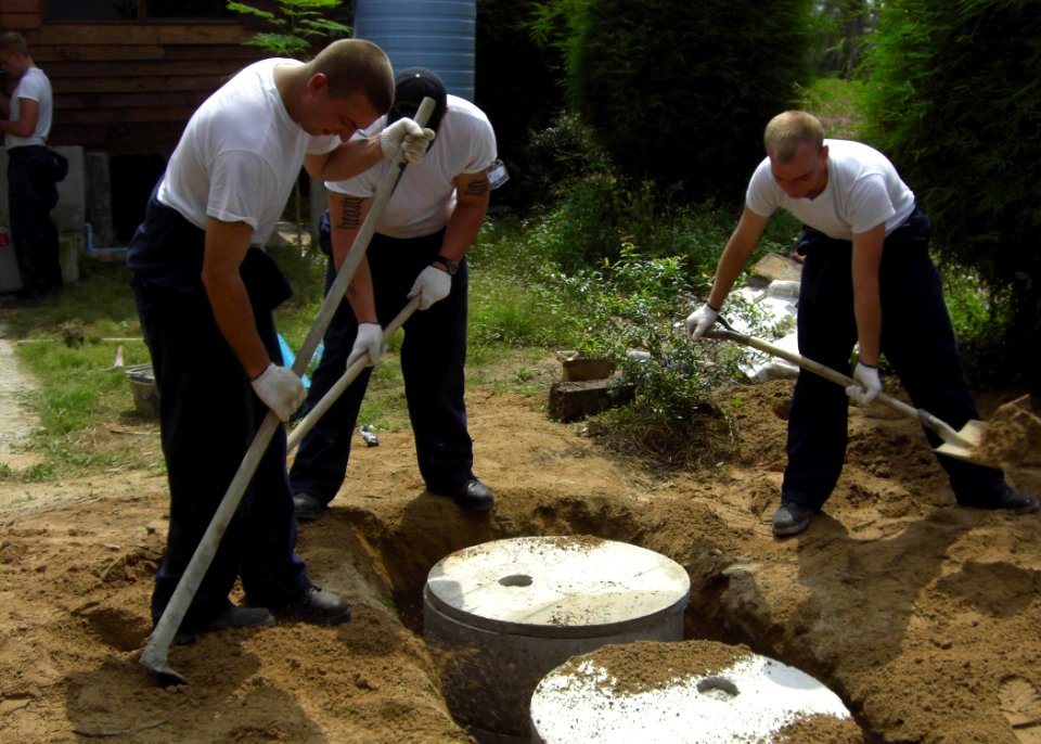 US Navy 091026-N-0000X-001 Sailors assigned to the Los Angeles attack submarine USS City of Corpus Christi (SSN-705) install a septic tank as part of a Habitat for Humanity Project