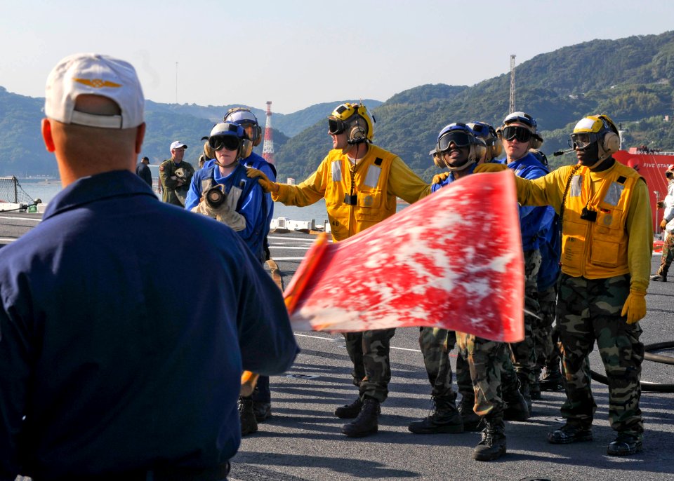 US Navy 091021-N-9950J-089 Sailors assigned to the air department of the forward-deployed amphibious assault ship USS Essex (LHD 2) participate in a fire drill for their annual Aviation Certification. Essex is in a ship's restr
