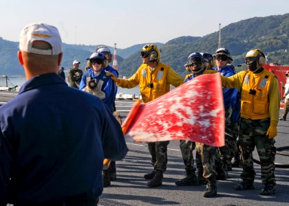 US Navy 091021-N-9950J-089 Sailors assigned to the air department of the forward-deployed amphibious assault ship USS Essex (LHD 2) participate in a fire drill for their annual Aviation Certification. Essex is in a ship's restr