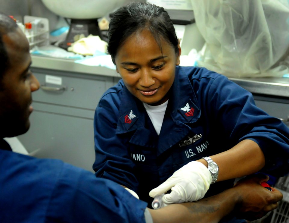 US Navy 091020-N-7280V-249 Hospital Corpsman 1st Class Alice Soriano draws blood from a Sailor aboard the amphibious command ship USS Blue Ridge (LCC 19)