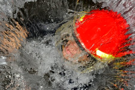 US Navy 091020-N-7498L-119 Damage Controlman 2nd Class Ken Wiseman climbs up a flooded hatch during damage control training at the Center of Naval Engineering Learning Site Pearl Harbor
