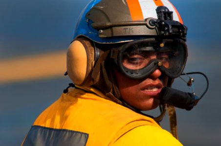 US Navy 091026-N-5319A-004 Aviation Boatswain's Mate (Handling) Airman Samual Meza, assigned to the amphibious assault ship USS Nassau (LHA 4), steers a flight deck tractor before flight operations