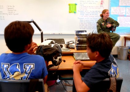 US Navy 091021-N-0535P-022 Naval Air Crewman 2nd Class Mehgan Rodriguez, assigned to Pacific Missile Range Facility, Kauai, Hawaii, describes her duties and experiences in the Navy during a career fair at Waimea Canyon Middle S