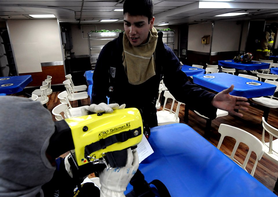 US Navy 091021-N-7280V-361 Damage Controlman Fireman Alfred Gonzales trains Sailors to use the Naval Firefighting Thermal Imager (NFTI) during a general quarters drill aboard the amphibious command ship USS Blue Ridge (LCC 19)