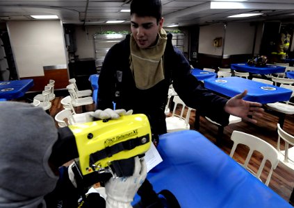 US Navy 091021-N-7280V-361 Damage Controlman Fireman Alfred Gonzales trains Sailors to use the Naval Firefighting Thermal Imager (NFTI) during a general quarters drill aboard the amphibious command ship USS Blue Ridge (LCC 19)