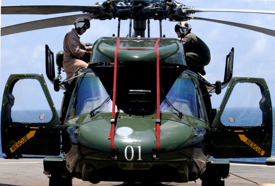 US Navy 091022-N-7478G-279 Lt. Cmdr. Loren Romeus, left, and Lt. Cmdr. Clark Hickingbottom, assigned to Helicopter Antisubmarine Squadron Light (HSL) 51, inspect an SH-60F Sea Hawk helicopter before flight quarters