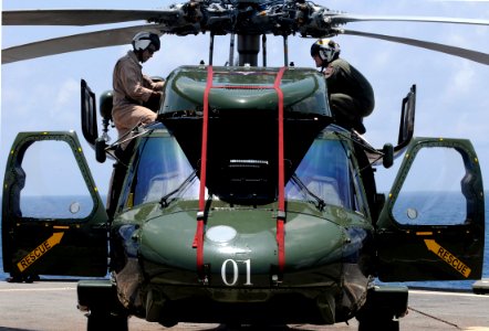 US Navy 091022-N-7478G-279 Lt. Cmdr. Loren Romeus, left, and Lt. Cmdr. Clark Hickingbottom, assigned to Helicopter Antisubmarine Squadron Light (HSL) 51, inspect an SH-60F Sea Hawk helicopter before flight quarters