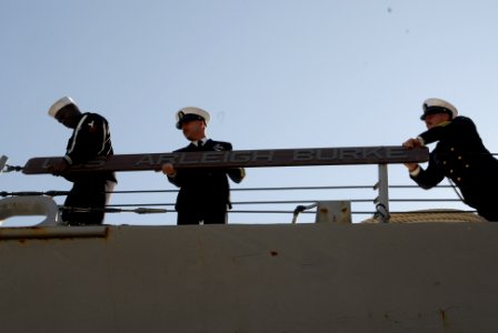 US Navy 091021-N-2456S-130 ailors aboard the guided-missile destroyer USS Arleigh Burke (DDG 51) install a battle board on the side of the ship after returning to Naval Station Norfolk