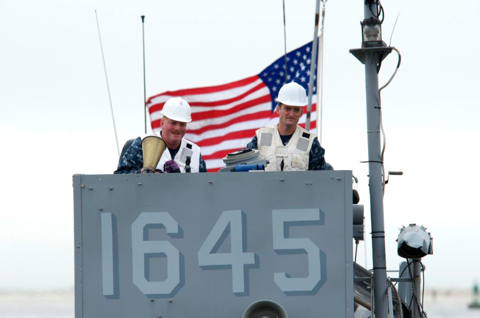 US Navy 091027-N-3592S-036 Boatswain's Mate 1st Class Bill Mowrey and Boatswain's Mate 1st Class Robert Dillard, craft masters aboard Landing Craft Utility 1645 (LCU 1645), await the embarkation of Marines from the 24th Marine
