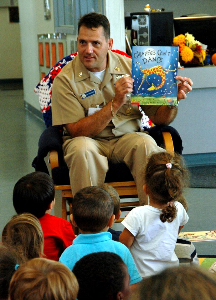 US Navy 091026-N-0311M-001 Naval Air Station Key West Command Master Chief Dan Messenger reads a book at the Naval Air Station Key West Child Development Center