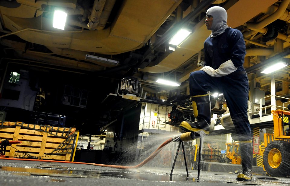 US Navy 091022-N-0890S-174 Operations Specialist Seaman David Mccatty tests his pipe patching skills during a general quarters drill aboard the multipurpose amphibious assault ship USS Wasp (LHD 1)