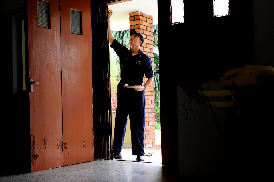 US Navy 091027-N-3830J-107 egalman 1st Class Kevin Jaress, assigned to the amphibious command ship USS Blue Ridge (LCC 19), paints a doorway at the Praise Emmanuel Children's Home during a community service project
