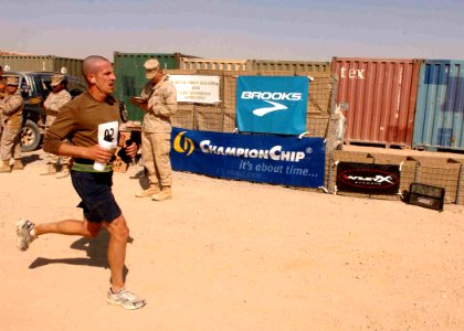 US Navy 091025-N-4440L-318 Lt. Paul Gundy, a Dental Officer assigned to Naval Mobile Construction Battalion (NMCB) 74 from Hattiesburg, Miss., crosses the finish line of the first Marine Corps Marathon held in Afghanistan