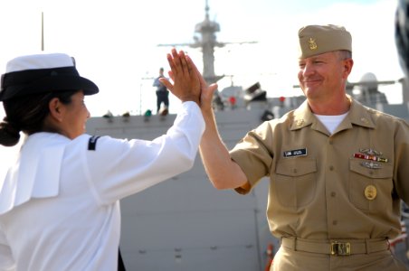 US Navy 091023-N-9689V-007 Master Chief Petty Officer of the Navy (MCPON) Rick D. West high-fives a Sailor assigned to the guided-missile destroyer USS Preble (DDG 88) during a visit to the San Diego region