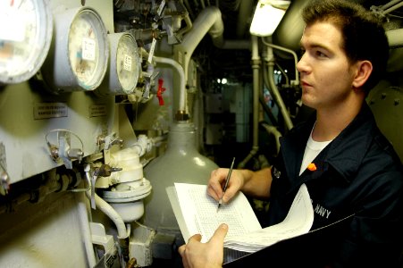 US Navy 091027-N-8960W-014 Machinist Mate Fireman Vincent Strickland records low-pressure air gauge readings aboard the aircraft carrier USS Nimitz (CVN 68)