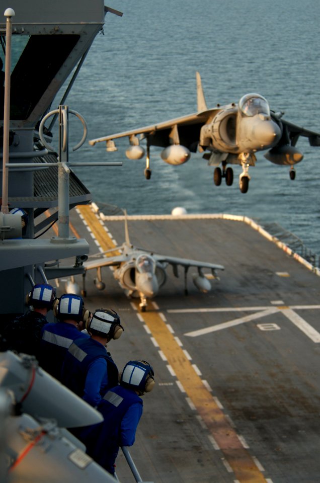 US Navy 091023-N-5319A-019 Sailors aboard the the amphibious assault ship USS Nassau (LHA 4) watch an approaching AV-8B Harrier from Marine Attack Squadron (VMA) 223 during a three-week Composite Unit Training Exercise (COMPTUE