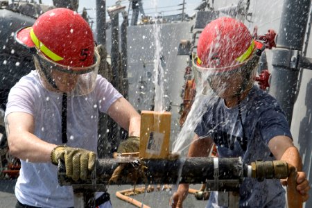 US Navy 091025-N-9123L-001 Culinary Specialist Seaman Dylan Smith, from St. Louis, Mo., and Boatswain's Mate 2nd Class Preston Rodgers, from Odessa, Texas, patch a ruptured pipe during a damage control Olympics event