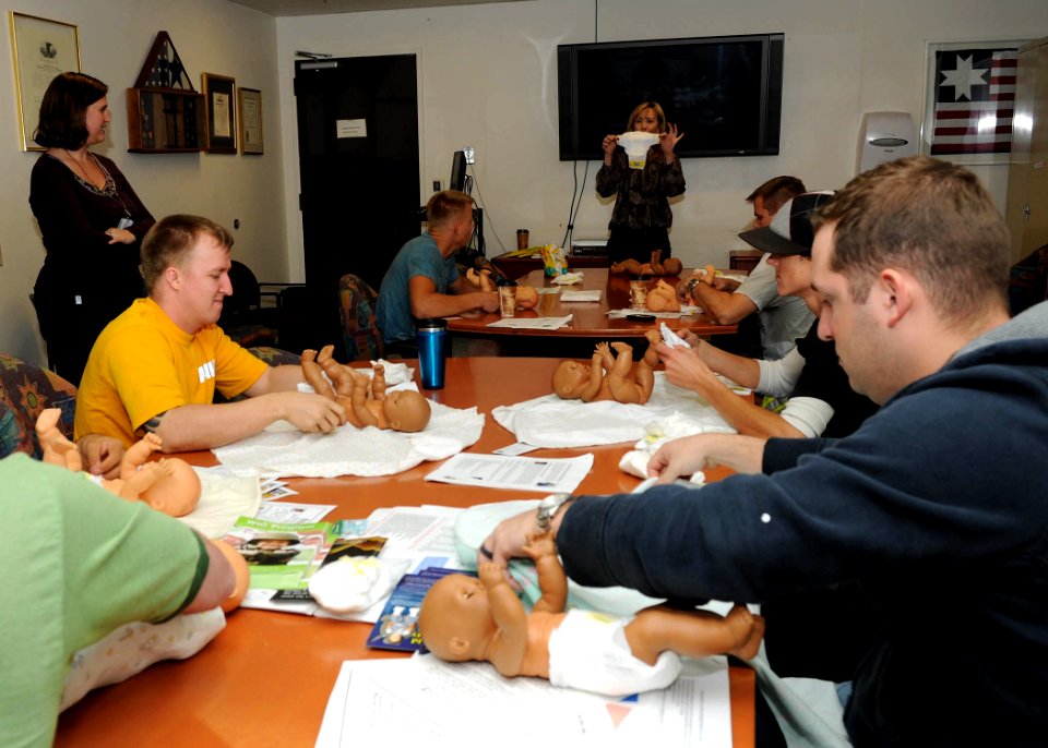 US Navy 091027-N-7214P-077 Expectant fathers are instructed on diaper changing during a Boot Camp for New Dads class