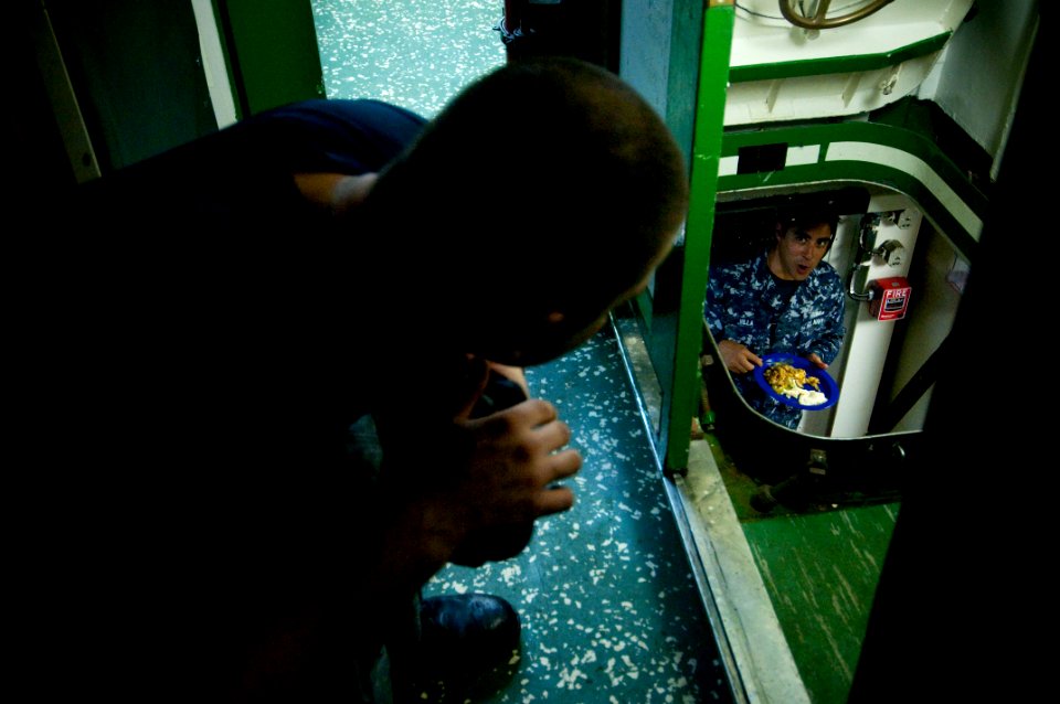 US Navy 091028-N-5319A-238 Engineman 2nd Class Steven Webber and Engineman 1st Class Aaron Villa eat breakfast before picking up Marines from the 24th Marine Expeditionary Unit