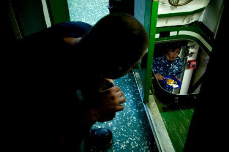 US Navy 091028-N-5319A-238 Engineman 2nd Class Steven Webber and Engineman 1st Class Aaron Villa eat breakfast before picking up Marines from the 24th Marine Expeditionary Unit