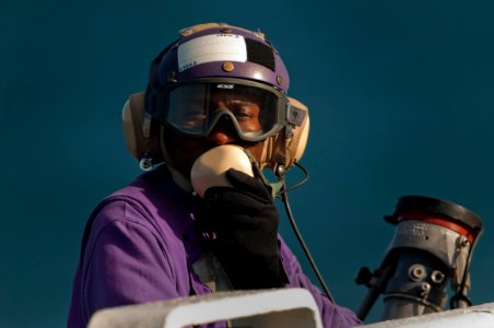 US Navy 091029-N-5319A-052 Aviation Boatswain's Mate (Fuels) 3rd Class Abdul Al Hassan waits for the start of flight operations aboard the amphibious assault ship USS Nassau (LHA 4)