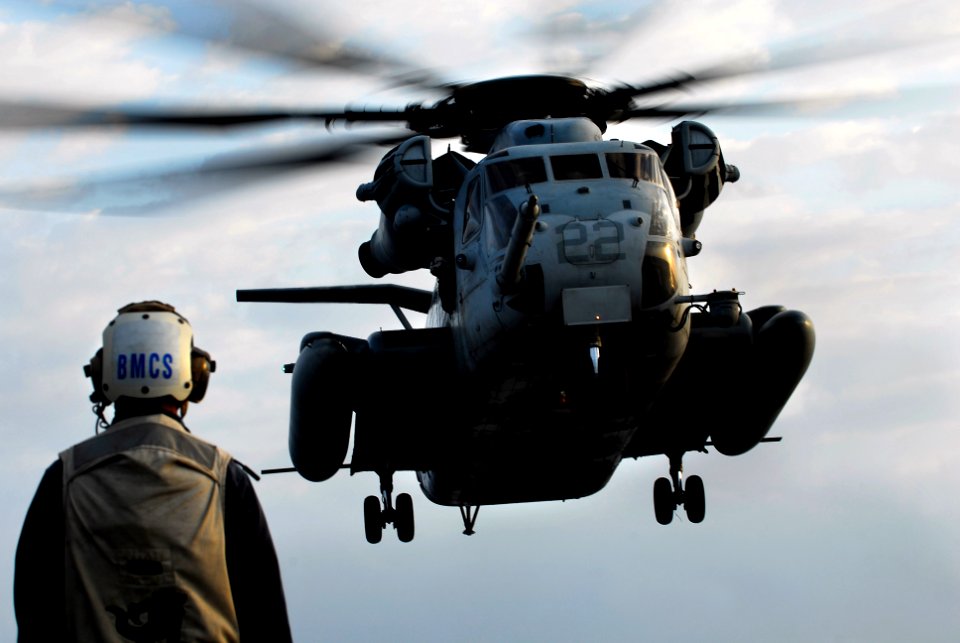 US Navy 091029-N-0807W-405 Flight deck safety officer, Senior Chief Boatswain's Mate Marvin Guinto, observes a Marine Corps CH-53E Sea Stallion helicopter as it approaches the flight deck of USS Harpers Ferry (LSD 49)