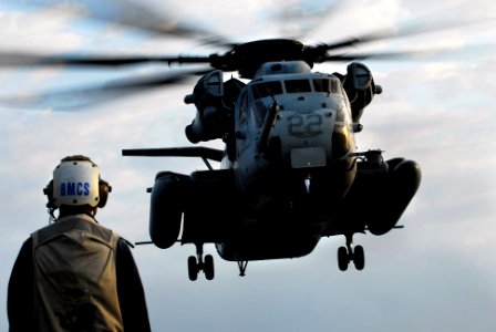 US Navy 091029-N-0807W-405 Flight deck safety officer, Senior Chief Boatswain's Mate Marvin Guinto, observes a Marine Corps CH-53E Sea Stallion helicopter as it approaches the flight deck of USS Harpers Ferry (LSD 49)