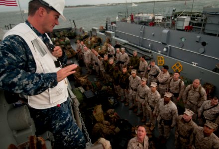 US Navy 091028-N-5319A-215 Boatswain's Mate 1st Class Robert Dillard watches as Marines from the 24th Marine Expeditionary Unit (24th MEU) load onto the Landing Craft Unit 1645 (LCU 1645) for a Composite Unit Training Exercise