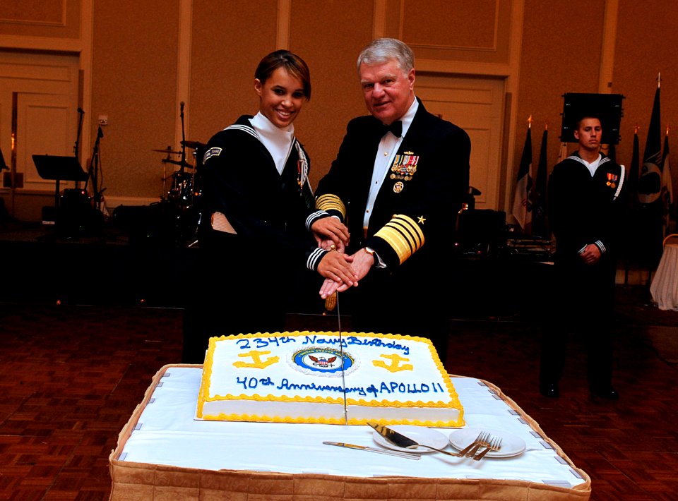 US Navy 091024-N-8273J-026 Chief of Naval Operations (CNO) Adm. Gary Roughead, right, and Airman Jessica Gill cut a cake to celebrate the Navy's 234th birthday