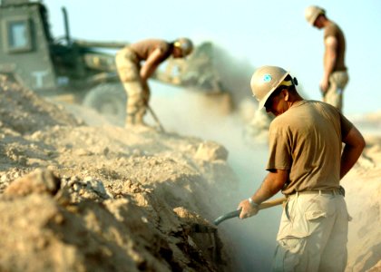 US Navy 091029-N-4440L-160 Seabees assigned to Naval Mobile Construction Battalion (NMCB) 74 bury two kilometers of fiber optic cable for their new camp in the expansion area of Camp Leatherneck, Afghanistan