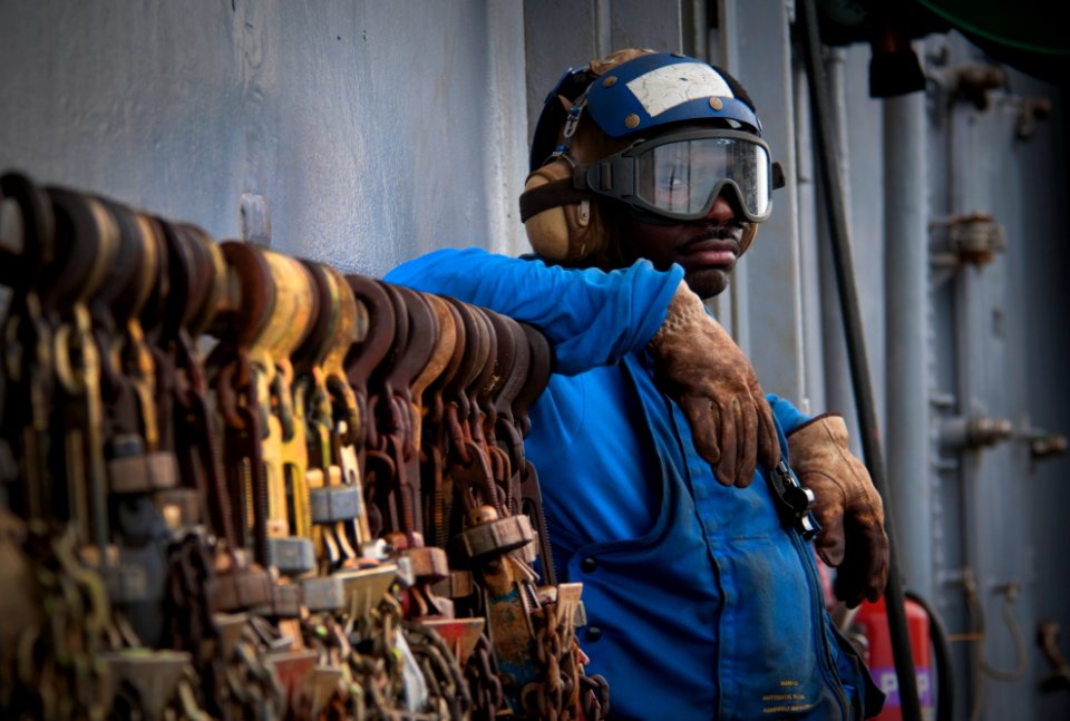 US Navy 091026-N-5319A-021 Aviation Boatswain's Mate (Handling) Airman Ronnie Hartford, assigned to the amphibious assault ship USS Nassau (LHA 4), relaxes before flight operations during a Composite Unit Training Exercise (COM