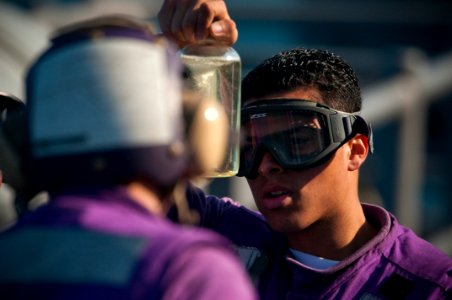 US Navy 091029-N-5319A-090 Aviation Boatswain Mate Fuels Airman Apprentice Luis Smith tests fuel before flight operations aboard the amphibious assault ship USS Nassau (LHA 4)