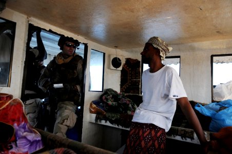 US Navy 091027-N-4154B-082 Lt. j.g. Jerod Hitzel, assigned to U.S. Coast Guard Maritime Safety and Security Team (MSST) 91104, interviews the master of a fishing vessel photo