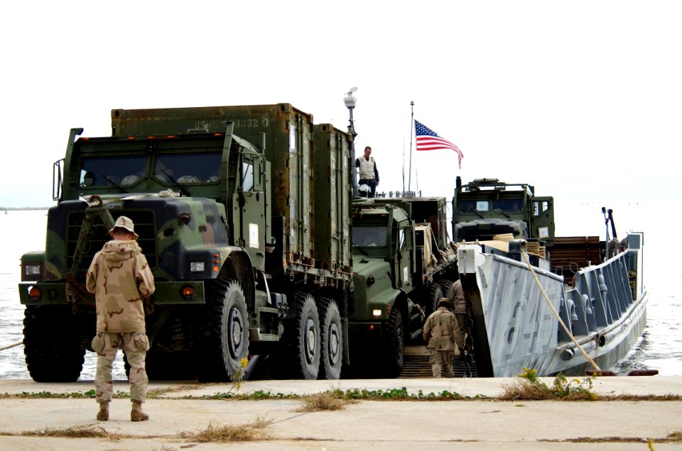 US Navy 091027-N-3592S-161 Seabees assigned to Beach Party Team 3 assist the crew of Landing Craft Utility 1645 (LCU 1645) with the embarkation of equipment from the 24th Marine Expeditionary Unit