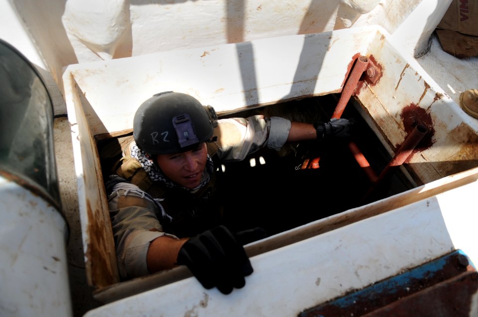 US Navy 091027-N-4154B-077 Machinery Technician 1st Class William Porter climbs out of a hold aboard a fishing vessel