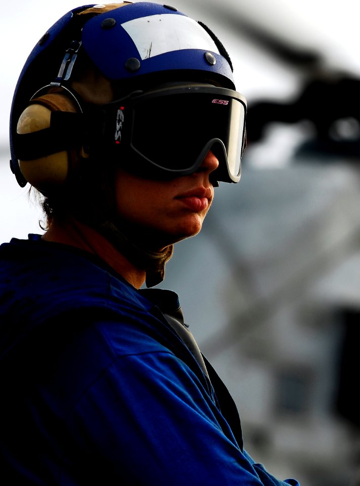 US Navy 091029-N-0807W-233 Seaman Kayla L. Gravdal assigned to the amphibious dock landing ship USS Harpers Ferry (LSD 49) stands by to retrieve chocks and chains from a Marine Corps CH-46 Sea Knight helicopter