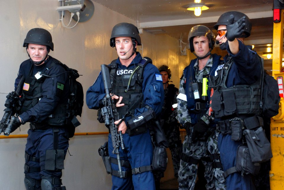 US Navy 091029-N-7095C-112 Lt. Colin Turner, assigned to U.S. Coast Guard Maritime Safety and Security Team San Diego (91109), directs a joint boarding team during an exercise aboard the Military Sealift Command fleet replenish
